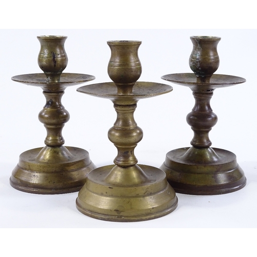 85 - A set of bronze candle stands, height 14cm