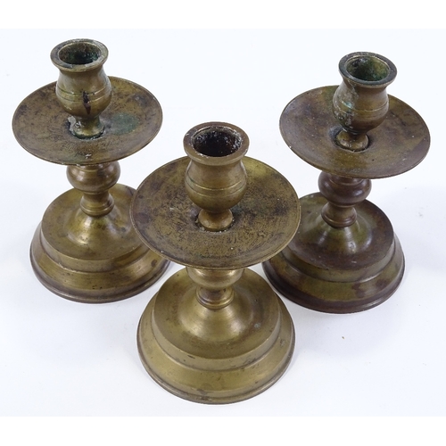 85 - A set of bronze candle stands, height 14cm