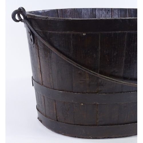 90 - A metal-bound stained wood oyster bucket, with iron swing handle, length 58cm