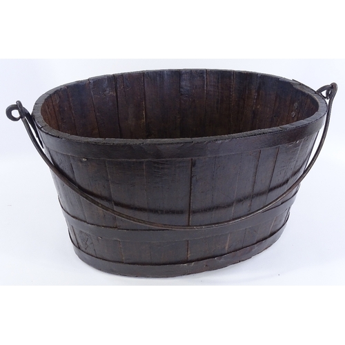 90 - A metal-bound stained wood oyster bucket, with iron swing handle, length 58cm