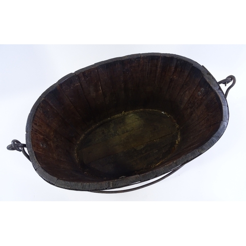 90 - A metal-bound stained wood oyster bucket, with iron swing handle, length 58cm