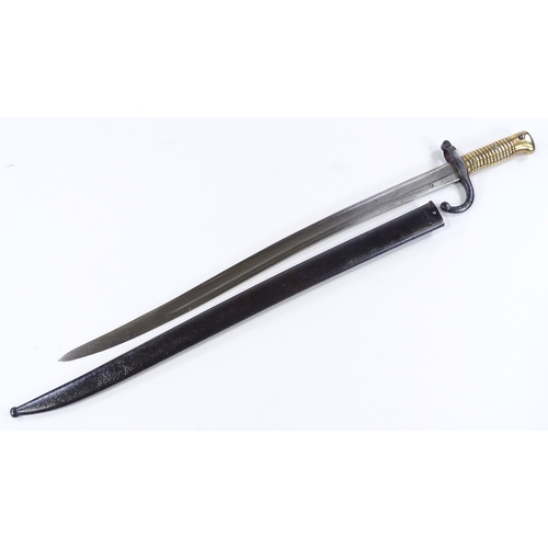 91 - A 19th century French sword bayonet, with brass hilt and original metal scabbard, dated 1872, blade ... 