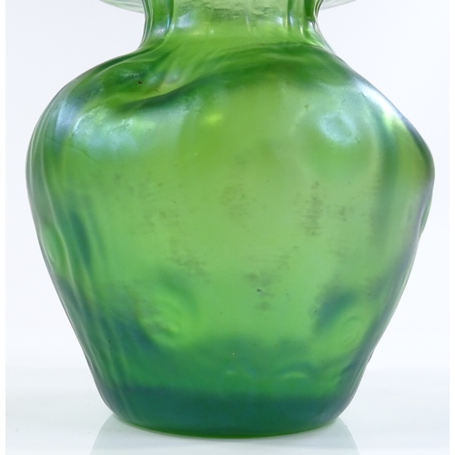 98 - A Loetz green iridescent glass dimpled vase, height 11cm