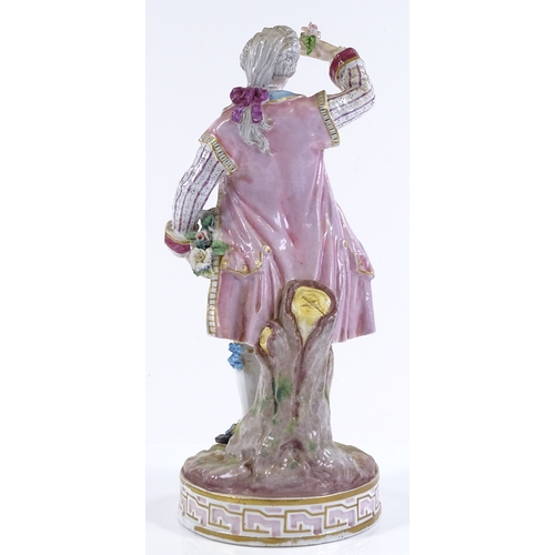 203 - A 19th century Continental porcelain figure of a man holding a basket of flowers, height 27cm