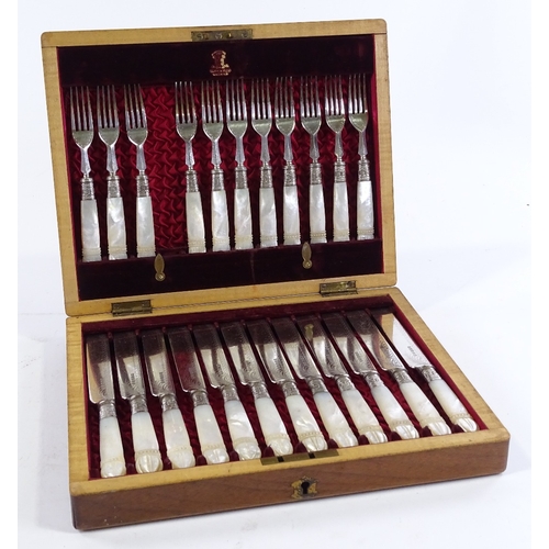 211 - A cased set of Victorian carved mother-of-pearl handled dessert knives and forks for 12 people (miss... 