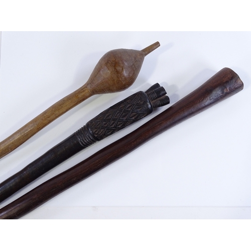 215 - 2 Ethnic clubs and a Tribal carved wood axe handle (3)