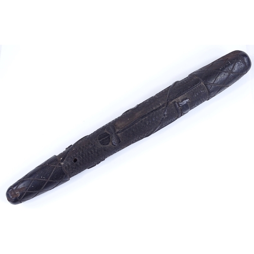 226 - An Irish relief carved bog oak club, length 42cm