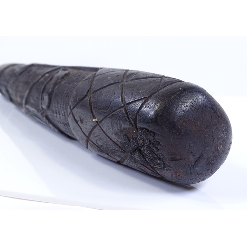 226 - An Irish relief carved bog oak club, length 42cm