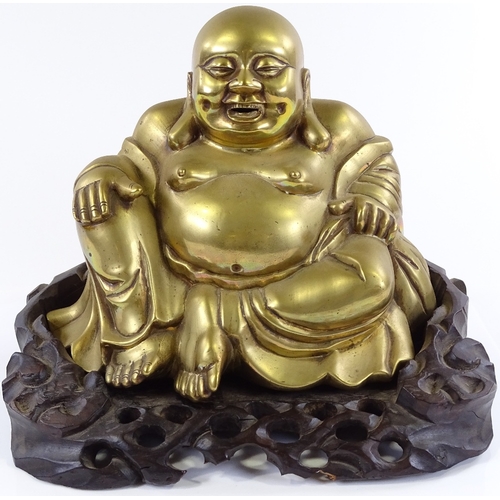 4 - A Chinese bronze seated Buddha on carved hardwood stand, overall height 26cm, stand width 31cm