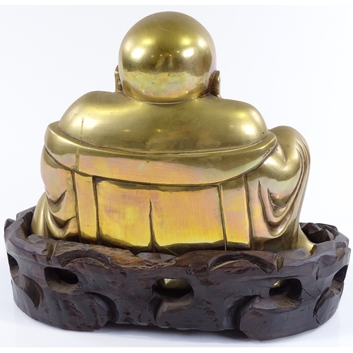 4 - A Chinese bronze seated Buddha on carved hardwood stand, overall height 26cm, stand width 31cm