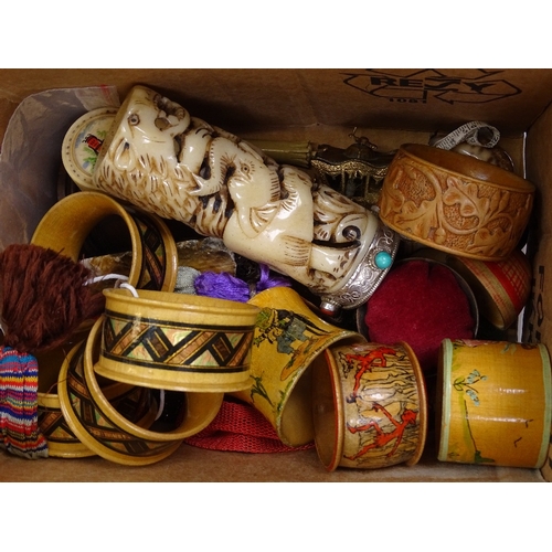 103 - A mixed box of items, including napkin rings, misers purses, a carved bone elephant design vase etc