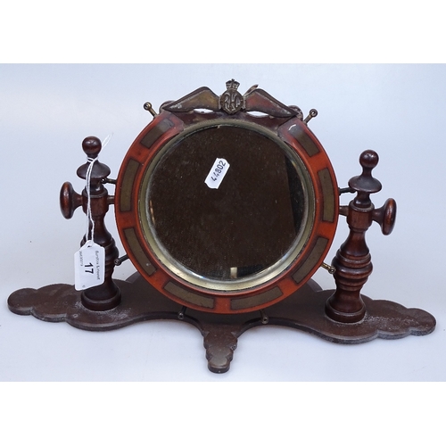 17 - A First War Period brass inlaid toilet mirror with RFC Wings mount, on Bakelite plinth, framed diame... 