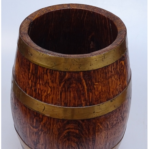 25 - A small ornamental brass-bound oak barrel, height 10