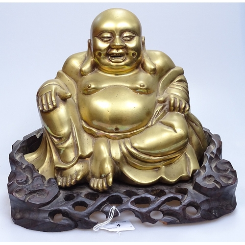 4 - A Chinese bronze seated Buddha on carved hardwood stand, overall height 26cm, stand width 31cm