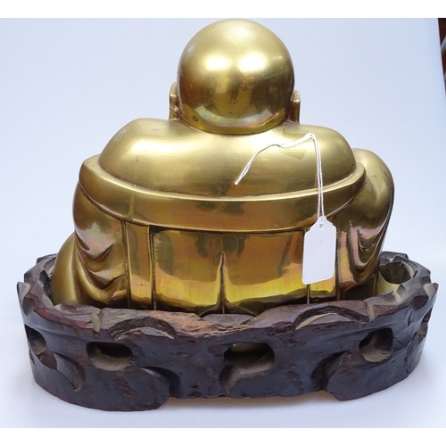 4 - A Chinese bronze seated Buddha on carved hardwood stand, overall height 26cm, stand width 31cm