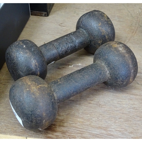 80 - A pair of Victorian cast-iron dumbbells with impressed maker's marks, length 7.5