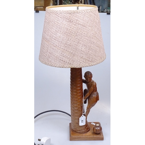 82 - An Indian carved wood table lamp, in the form of a boy climbing a palm tree, height excluding fittin... 