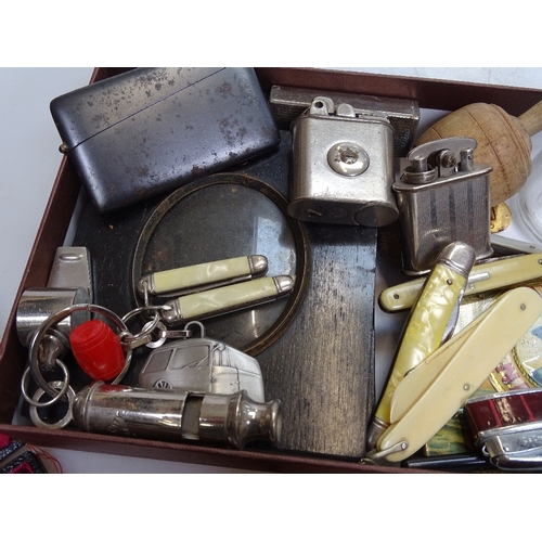 84 - A mixed box of items, including medallions, penknives, miniature frames, pocket lighters, a medal fo... 