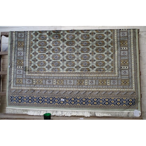 1828 - A green ground Bokhara carpet, 230cm x 160cm