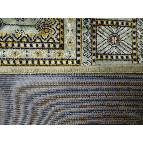 1828 - A green ground Bokhara carpet, 230cm x 160cm