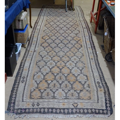 1831 - A long cream ground Kilim runner, with symmetrical brown border, 11'9