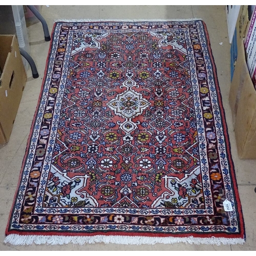 1832 - A red ground wool Persian style rug, 120cm x 80cm