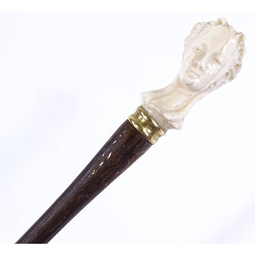 102 - An early 20th century rosewood parasol handle, with carved ivory woman's head terminal