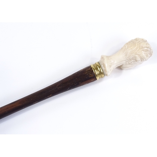 102 - An early 20th century rosewood parasol handle, with carved ivory woman's head terminal