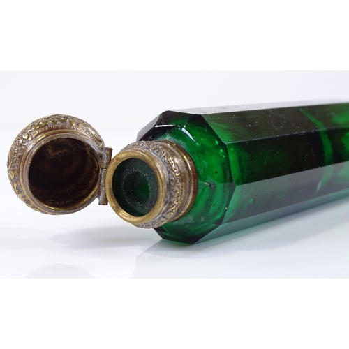 103 - A Victorian Bristol Green facet-cut glass double-ended perfume bottle, with gilt-brass tops, length ... 