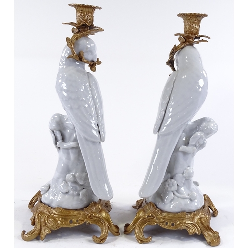 111 - A pair of white glaze porcelain parakeet candle holders, with ornate gilt-metal mounts, height 36cm