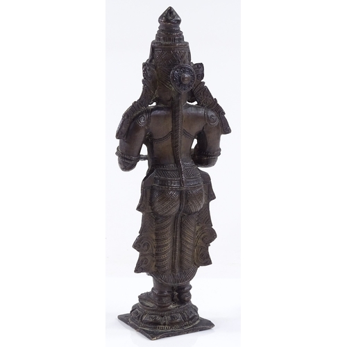 117 - An Antique Indian patinated bronze standing figure of a god, height 24cm