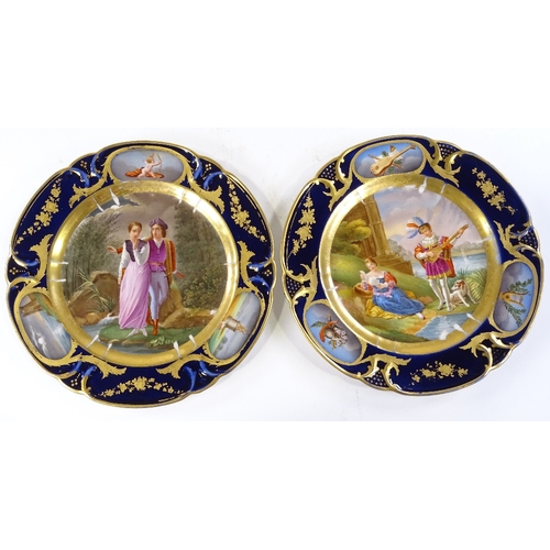 132 - A pair of 19th century Paris porcelain plates, with hand painted romantic panels in blue and gilt bo... 