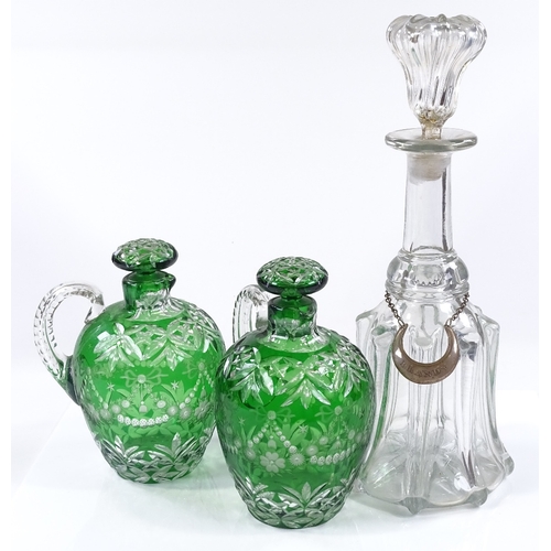 34 - A pair of green overlay cut-glass flasks, with original overlay stoppers, height 18cm, and a glass m... 