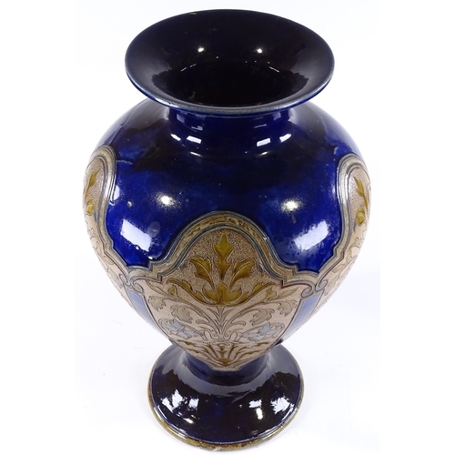60 - A large Royal Doulton stoneware blue ground vase, circa 1900, with panels of incised floral decorati... 