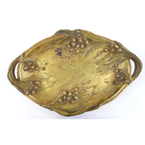 64 - A Bouny, gilt patinated bronze 2-handled dish, with relief cast floral decoration, signed, length 26... 