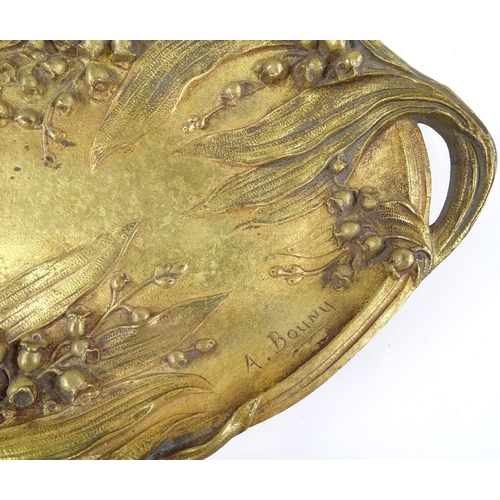 64 - A Bouny, gilt patinated bronze 2-handled dish, with relief cast floral decoration, signed, length 26... 