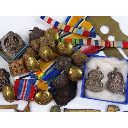 78 - A collection of military medals, badges, buttons and ribbons