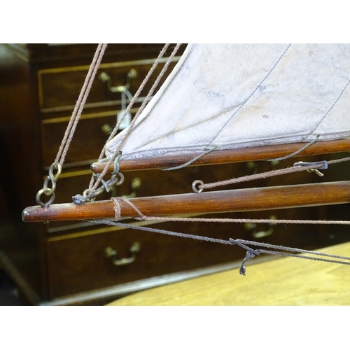 51 - A Victorian wooden-hulled pond yacht, with original sails and rigging, hull length 92cm, overall hei... 