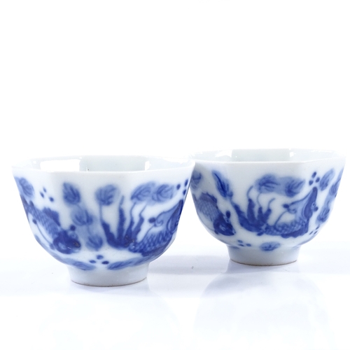 100 - A pair of Chinese blue and white porcelain tea bowls of octagonal form, with hand painted carp desig... 