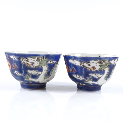 101 - A pair of Chinese blue and red glaze porcelain tea  bowls, with hand painted dragon enamel decoratio... 