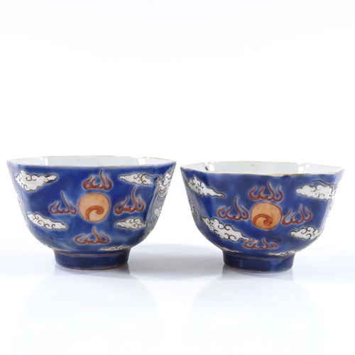 101 - A pair of Chinese blue and red glaze porcelain tea  bowls, with hand painted dragon enamel decoratio... 