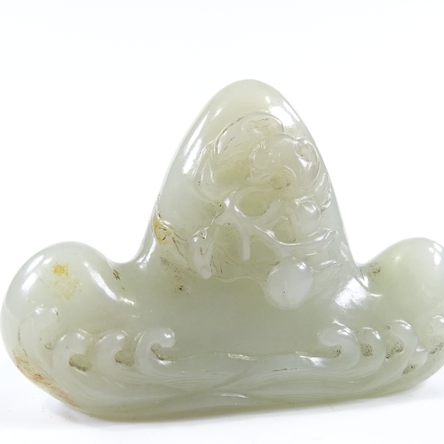 104 - A Chinese relief carved jade calligraphy pen-rest, with wave designs, length 8cm