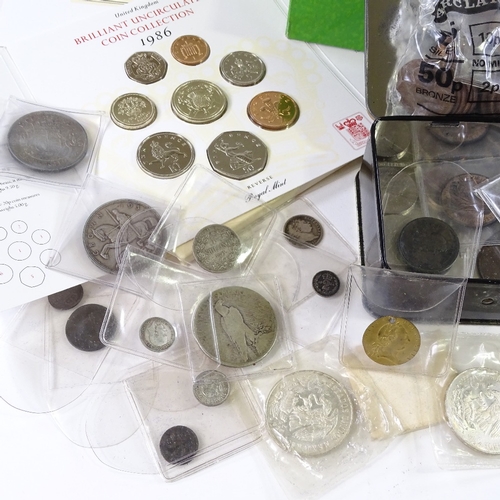 122 - A collection of coins and tokens, including some silver