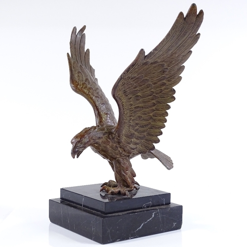 126 - An early 20th century patinated spelter sculpture of an eagle, unsigned, on black marble plinth, win... 