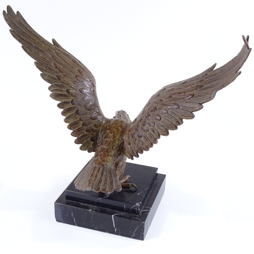 126 - An early 20th century patinated spelter sculpture of an eagle, unsigned, on black marble plinth, win... 