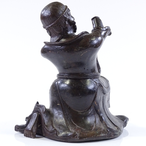 127 - An Antique Oriental patinated bronze kneeling figure, probably 18th or 19th century, height 23cm