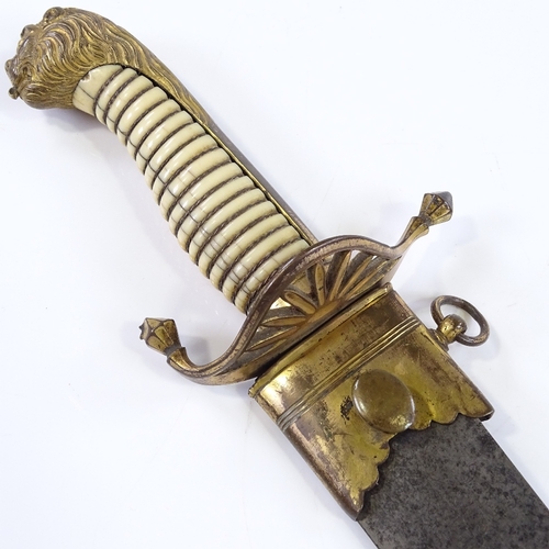 129 - A Georgian Naval Officer's dirk, with gilt-brass lion head pommel and etched blade, with gilt-brass ... 