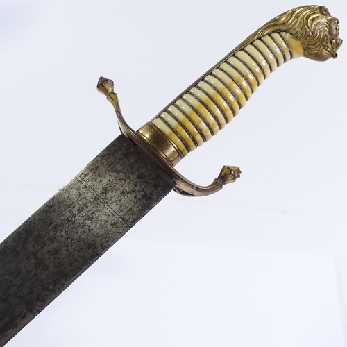 129 - A Georgian Naval Officer's dirk, with gilt-brass lion head pommel and etched blade, with gilt-brass ... 