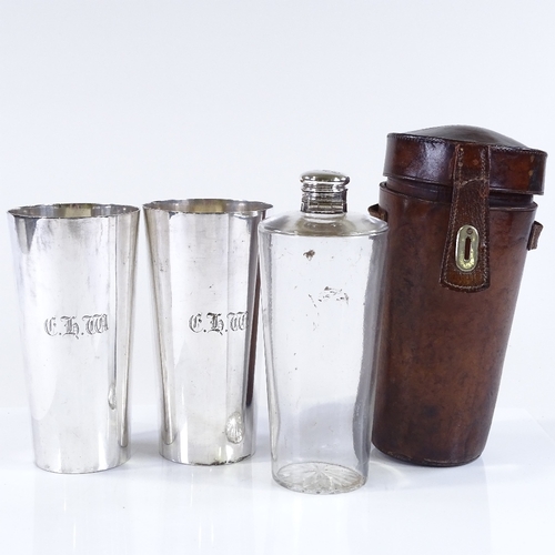 132 - A Victorian leather-cased travelling spirit bottle, and a pair of matching electroplate beakers, bea... 