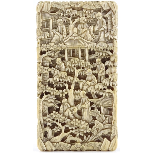15 - A 19th century Chinese relief carved ivory card case, decorated with figures and pagodas in gardens,... 